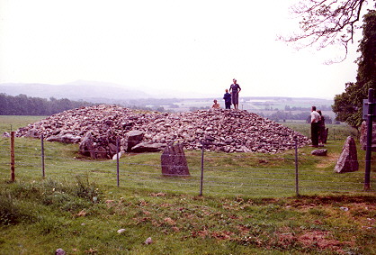 Corrimony cairn with visitors